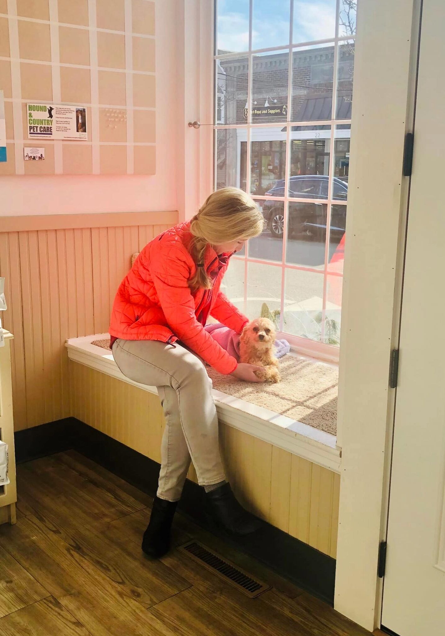 Dr Pierce With Small Dog by large window Dr Pierce With Small Dog by large window